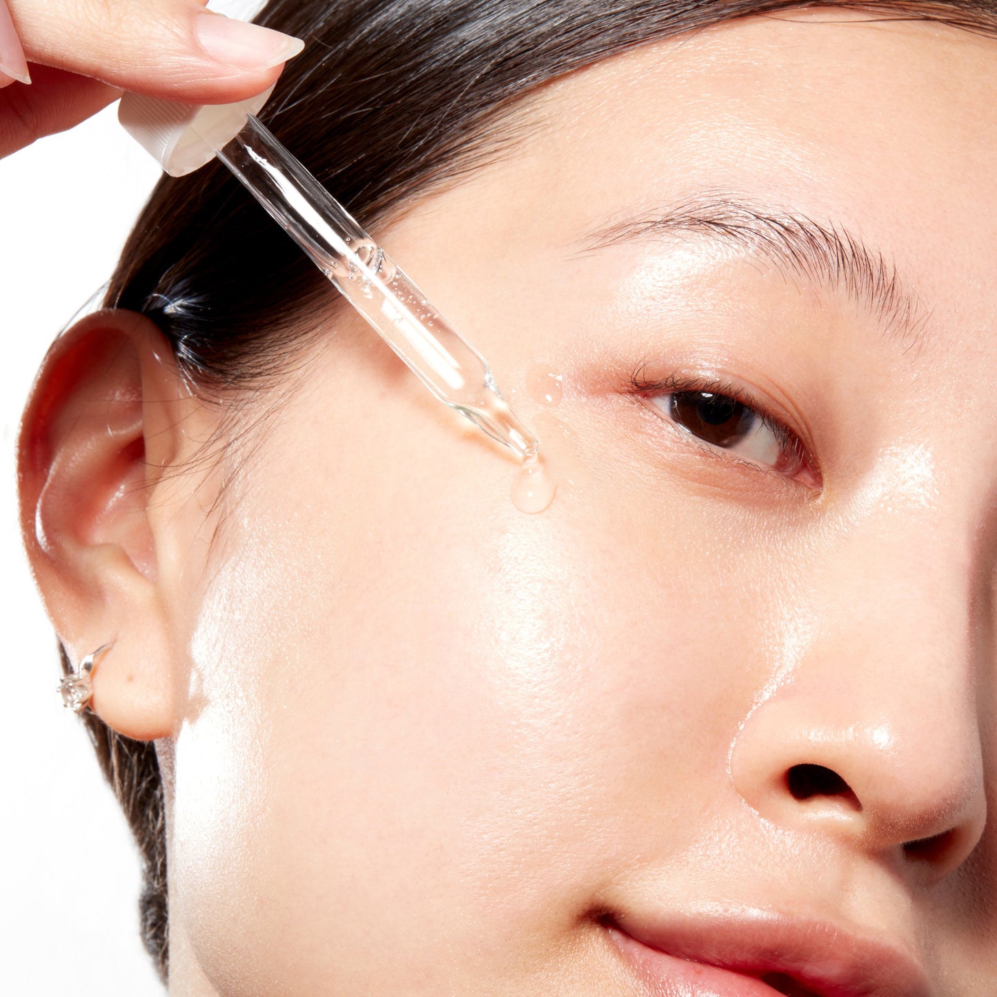 Woman demonstrating how to apply Super Peptide Serum