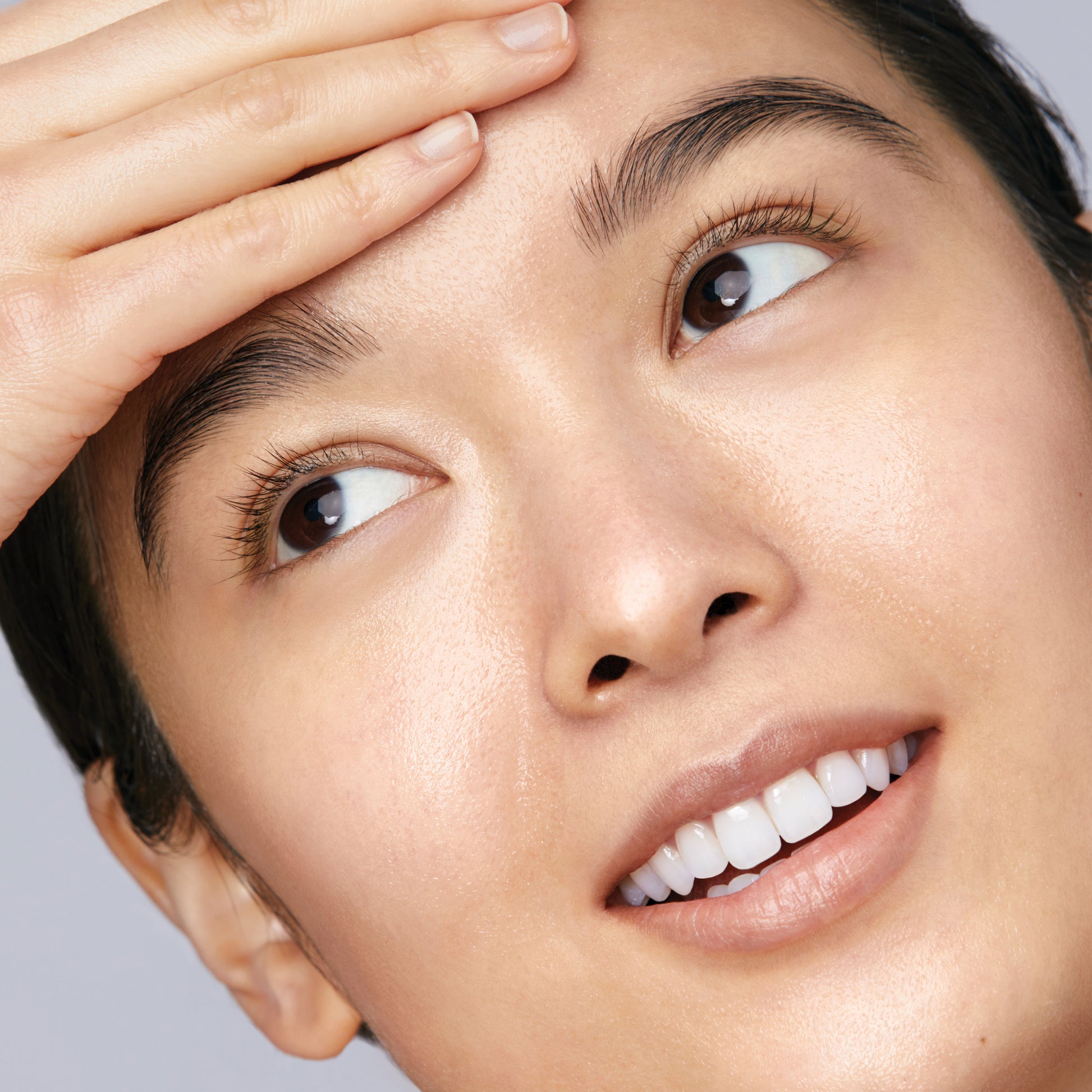 Woman showing results of Cleansing Oil 