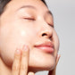 Woman demonstrating how to apply Hydrating Overnight Face Mask with Peptides 