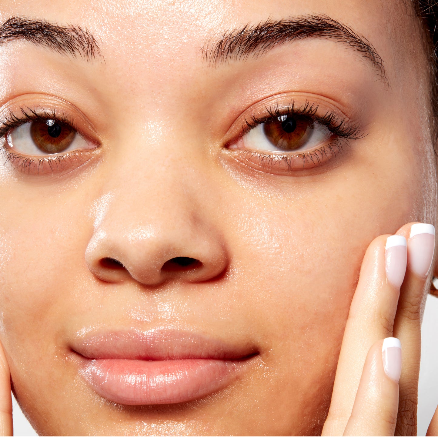 Woman demonstrating how to apply Oil Free Moisturizer SPF 30