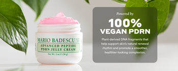 Jar of Mario Badescu PDRN cream with green leaves in the background