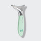 Mint green and silver skincare tool on a light gray background