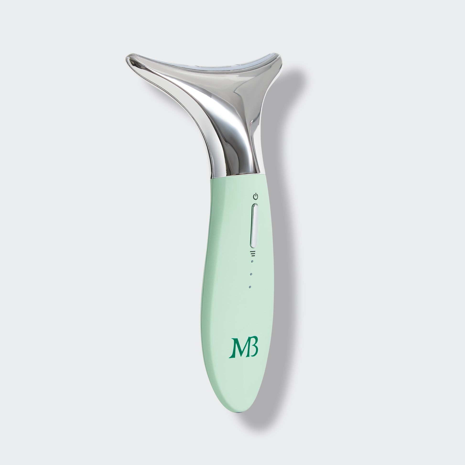 Mint green and silver skincare tool on a light gray background