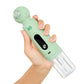 Hand holding a green handheld device with a clear attachment on a white background