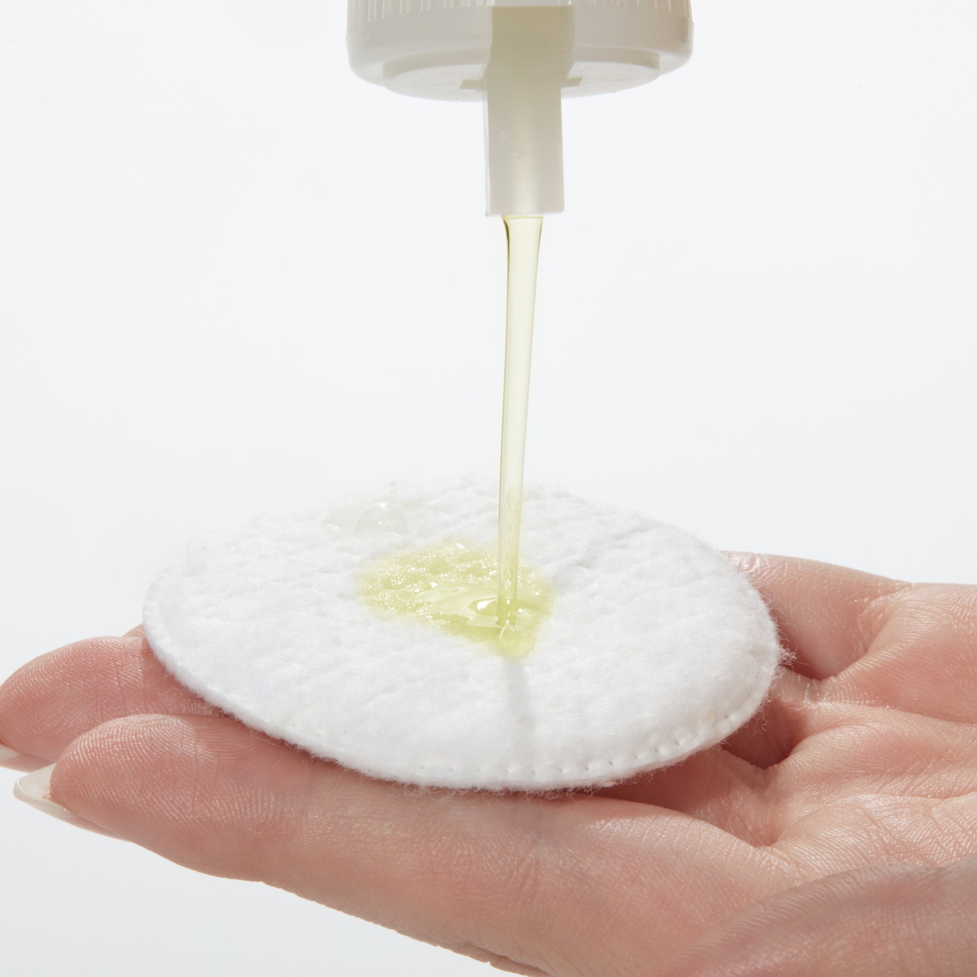 Demonstration showing  Special Cleansing Lotion "O" on a cotton pad 