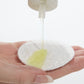 Demonstration showing Special Cucumber Lotion on a cotton pad
