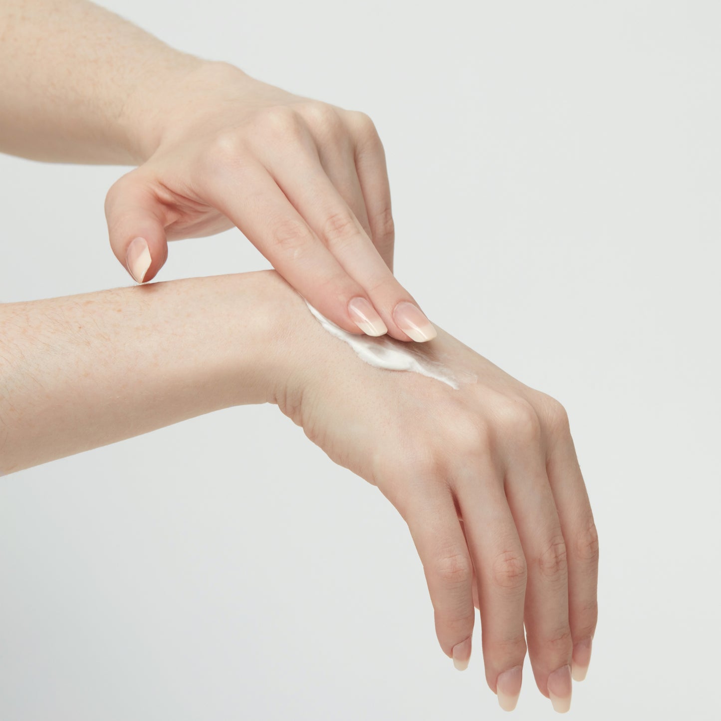 Rose Hand Cream with Vitamin E Being Applied To The Back Of A Hand 