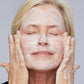 Woman demonstrating how to apply Glycolic Foaming Cleanser