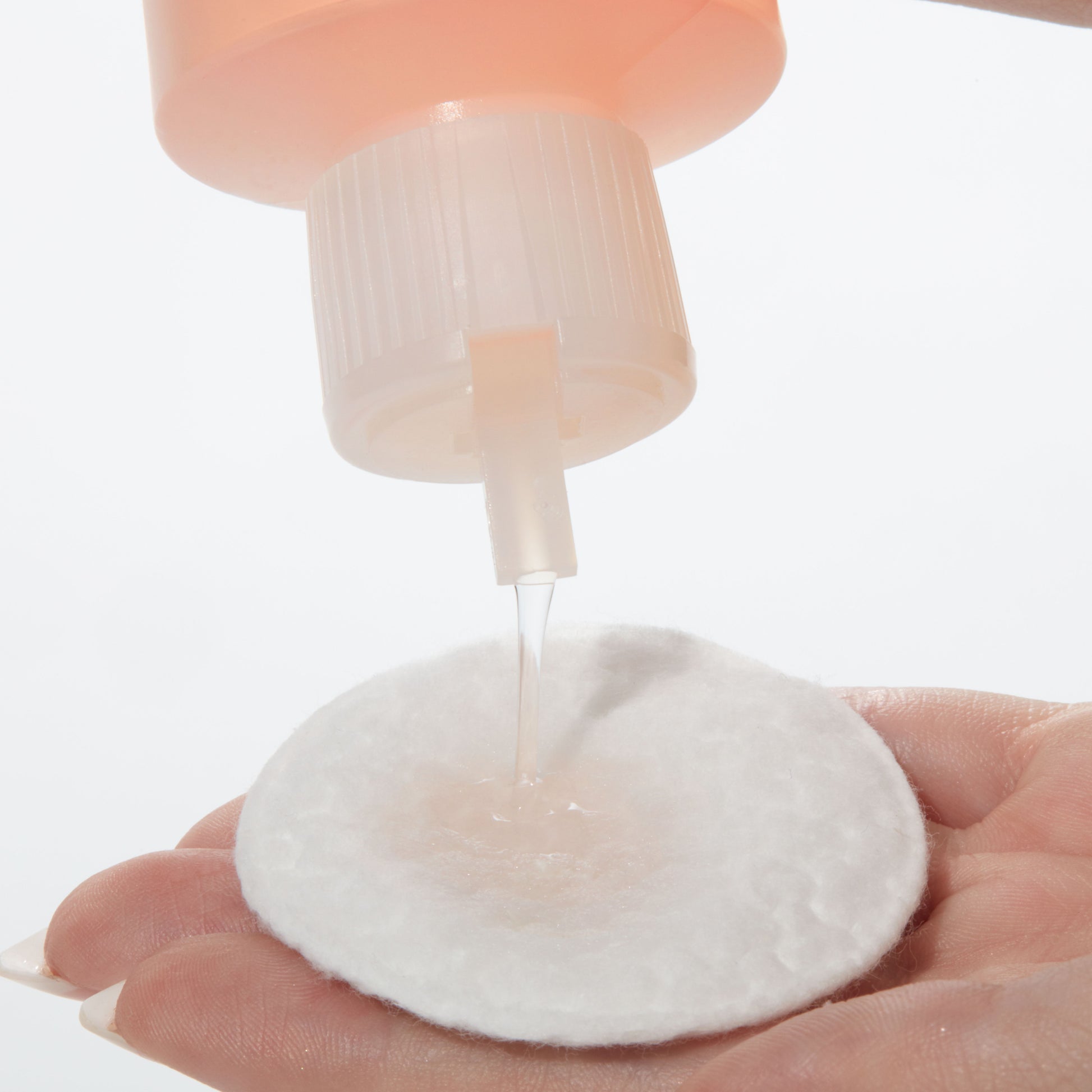 Demonstration showing how to use Grapefruit Brightening Toner with AHA on a cotton pad