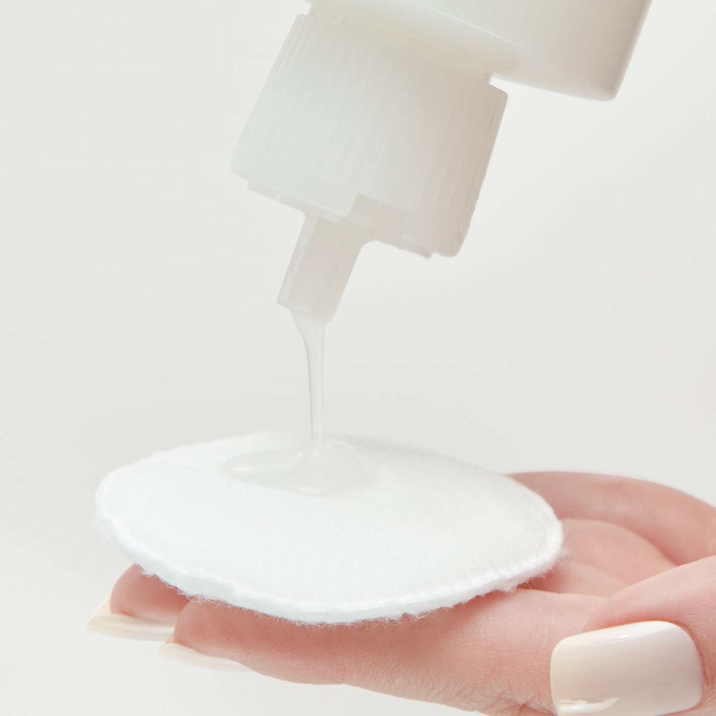  Demonstration showing how to use Hydrating Glow Toner on a cotton pad 